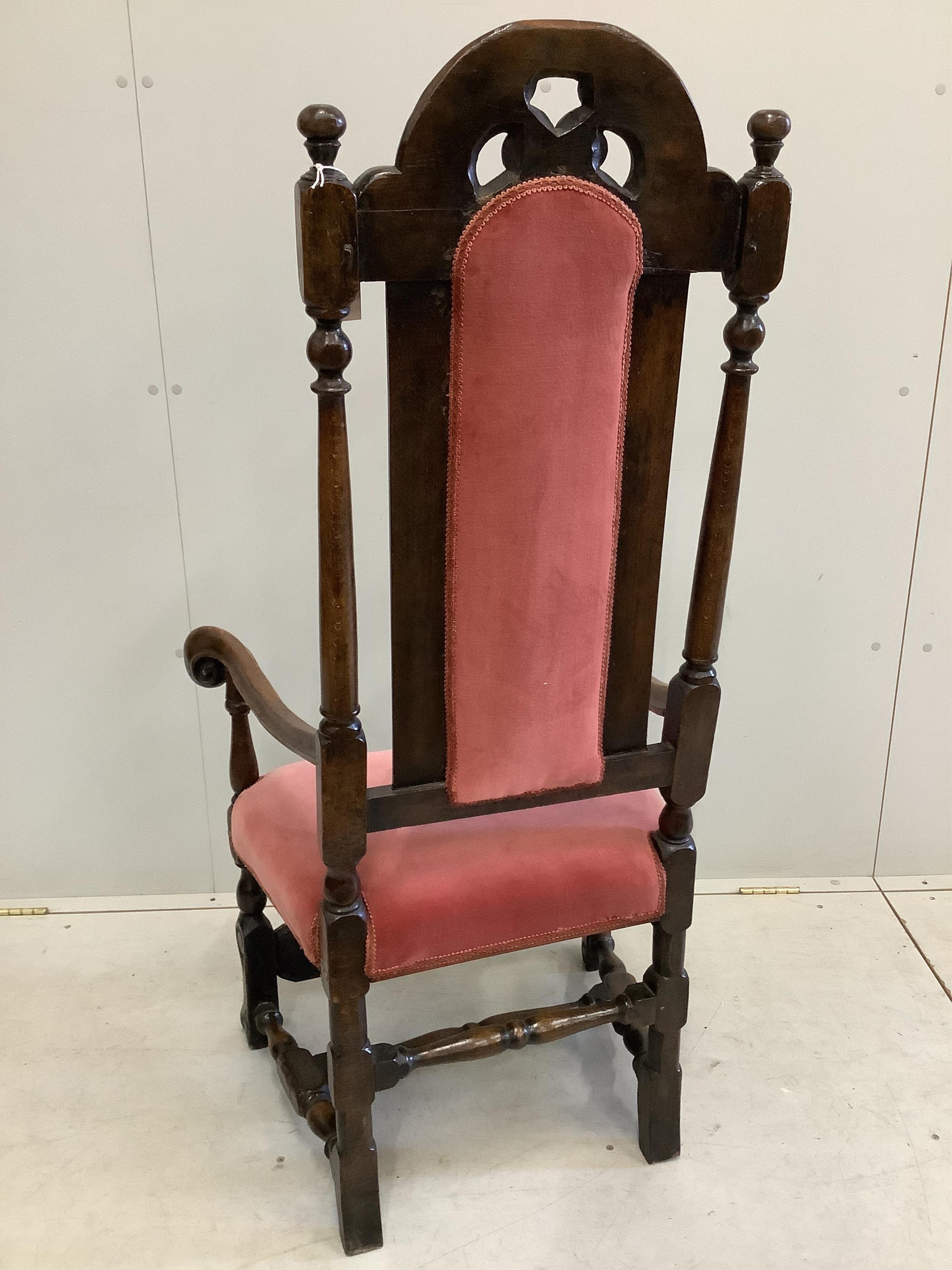 A Carolean style beech and walnut high back elbow chair, width 63cm, depth 46cm, height 130cm. Condition - good